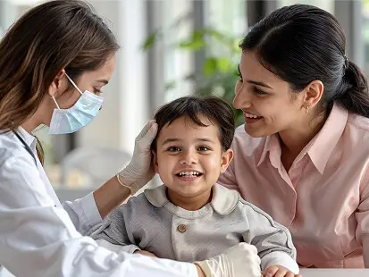 Doctor examining a smiling child with his mother during a clinic visit