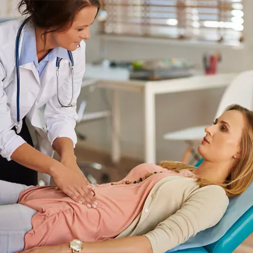 Chronic pelvic pain treatment in Delhi: doctor examining a woman's abdomen