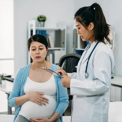 High-risk pregnancy management in Delhi: doctor reviewing a pregnant patient's reports